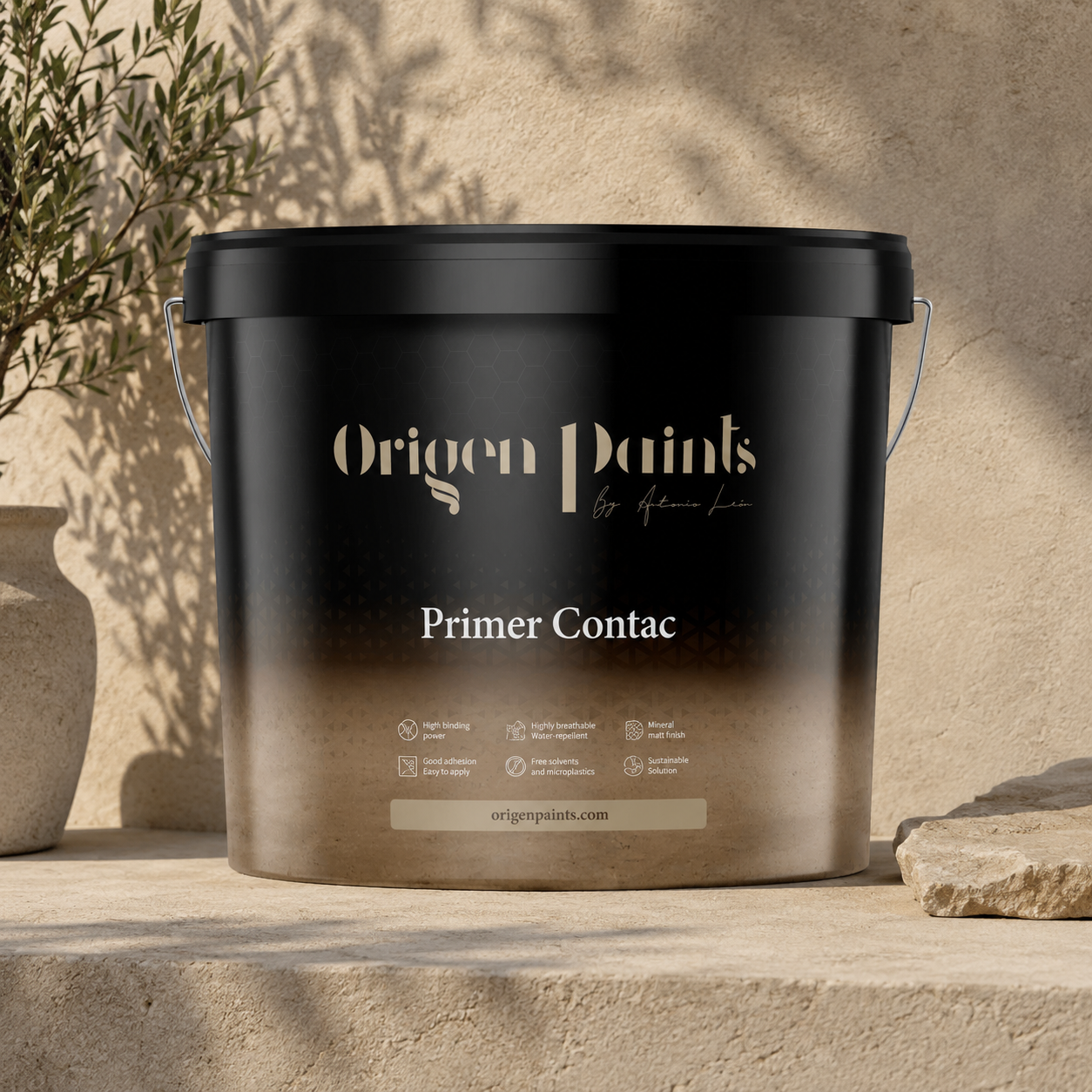 Black paint bucket labeled 'Origen Paints' on a stone surface with a natural background