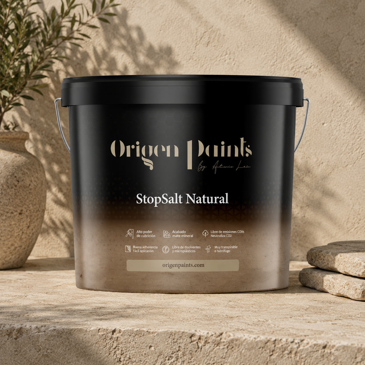 Black paint bucket labeled 'Origen Paints StopSalt Natural' on a stone surface with a natural background.