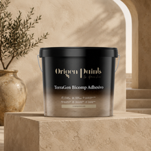Black bucket of Origen Paints TerraGen Bicomp Adhesivo on a stone surface with a neutral background